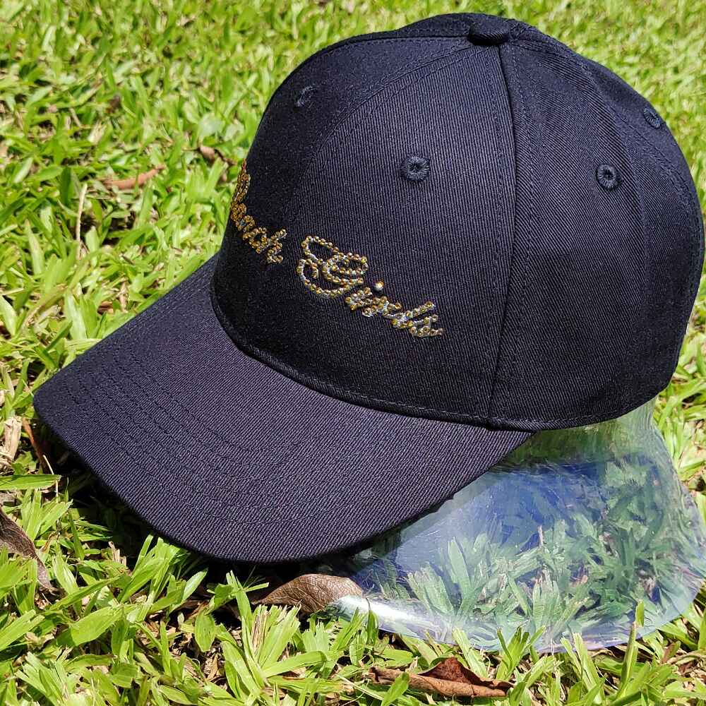 Topone Custom Rhinestones Pattern onto flat embroidery of front panels solid navy color cotton twill baseball caps Left View